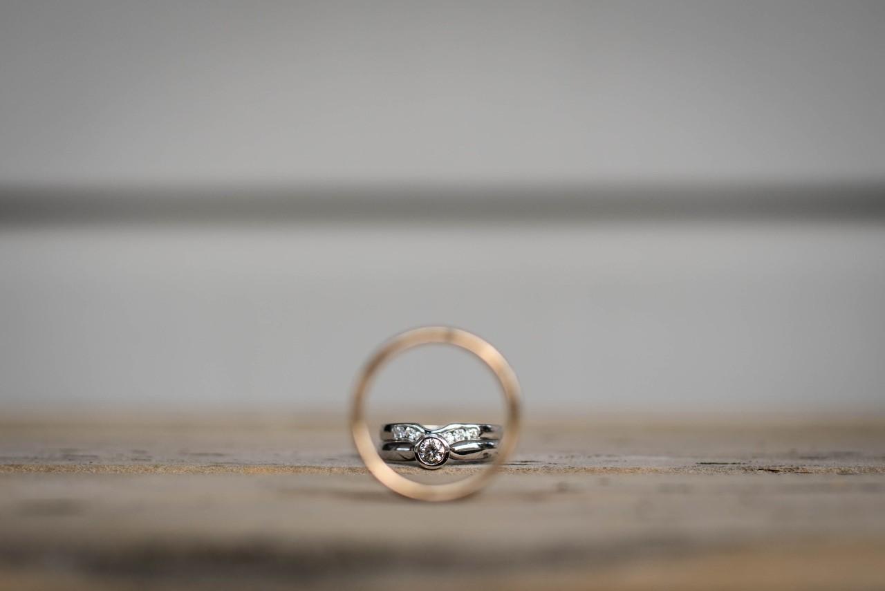 two wedding rings on a gray background