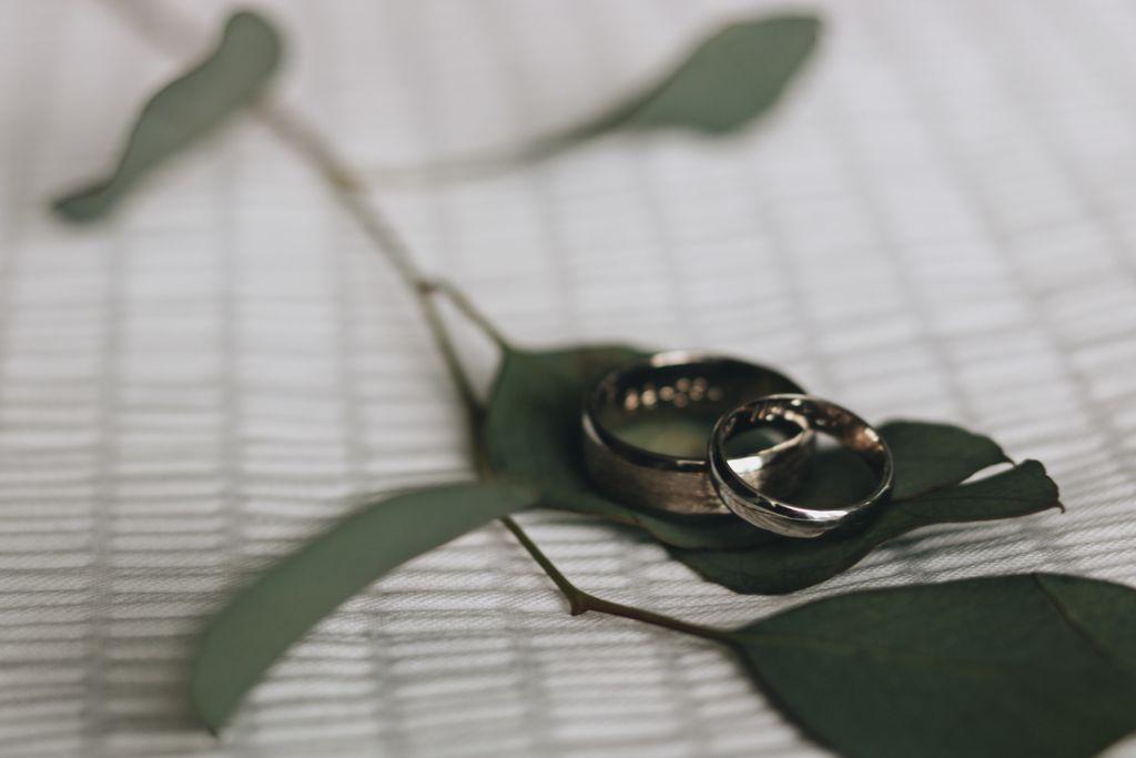 two wedding bands resting on a leaf