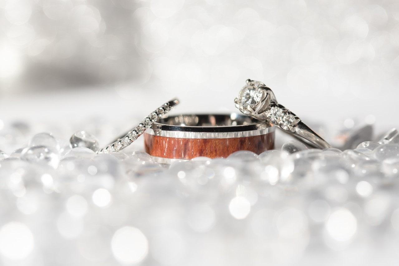 three wedding bands on a sparkling background