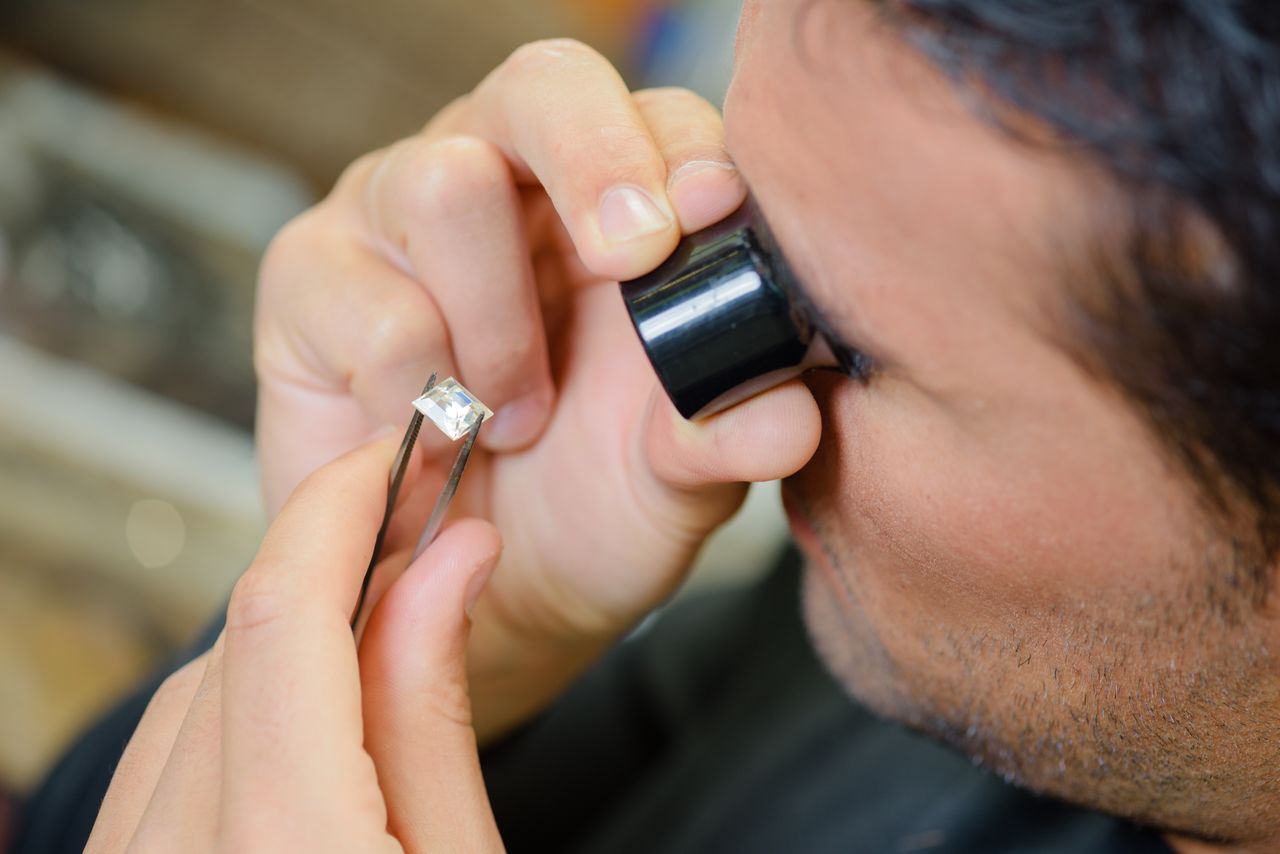 Gemologist inspecting a diamond for quality