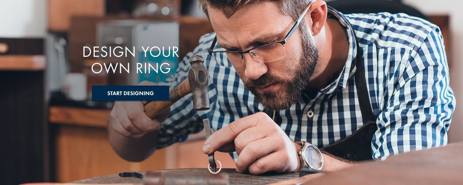 A craftsman at Thom Duma Fine Jewelers working on a custom ring, next to a button directing you to the custom engagement ring design page.