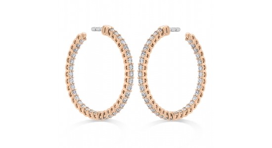 A pair of rose gold and diamond hoop earrings by Hearts On Fire, available at Thom Duma Fine Jewelers.