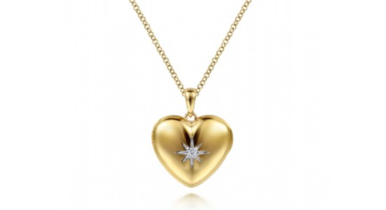 a yellow gold heart pendant necklace featuring a diamond star at its center