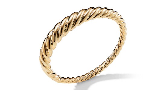 a textured, yellow gold bangle bracelet with textured details