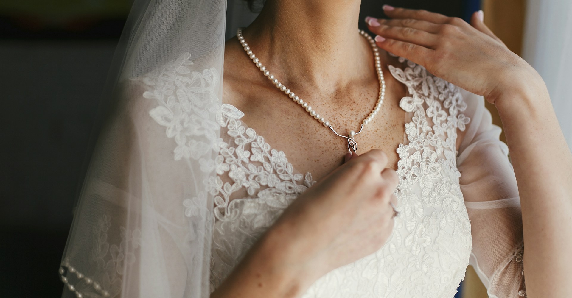 a lady wearing a pearl necklace