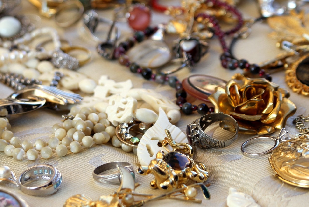 A close-up of a variety of jewelry, including multiple gold pieces.