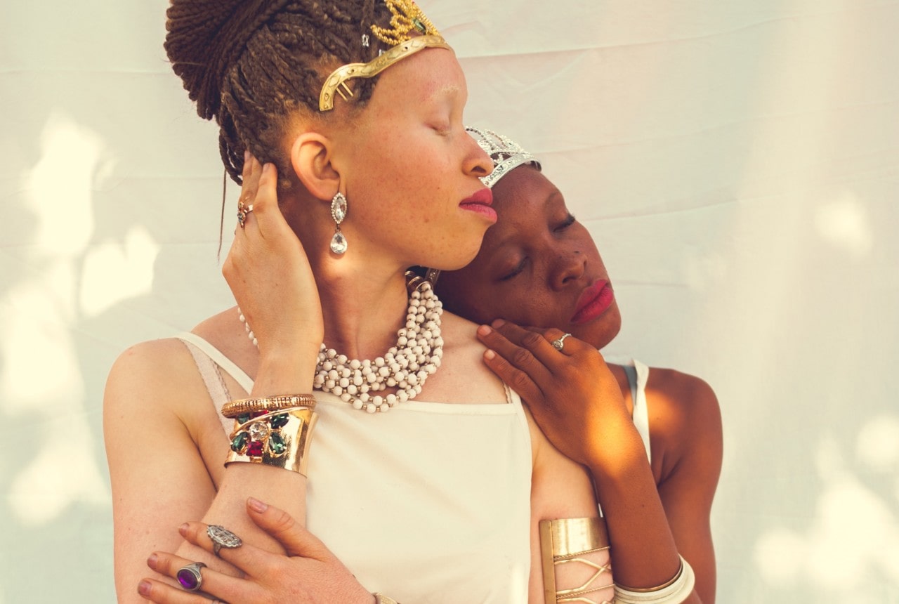 Two women adorned in lavish gold jewelry.