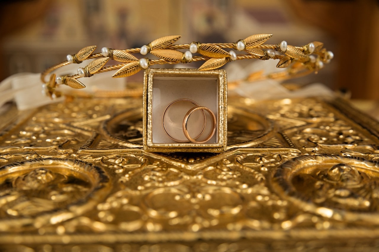 Stunning gold jewelry displayed atop a gold jewelry box.