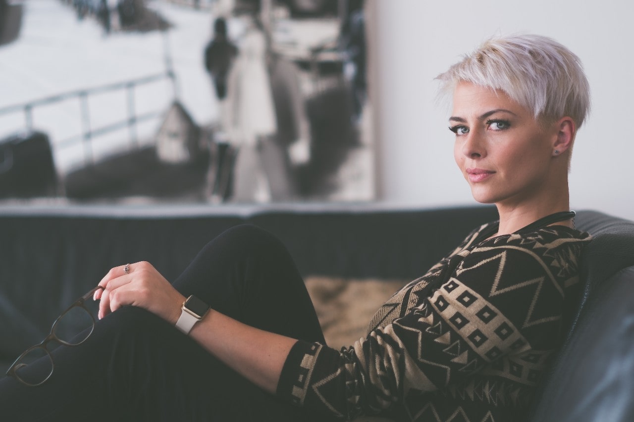 woman on couch with diamond studs