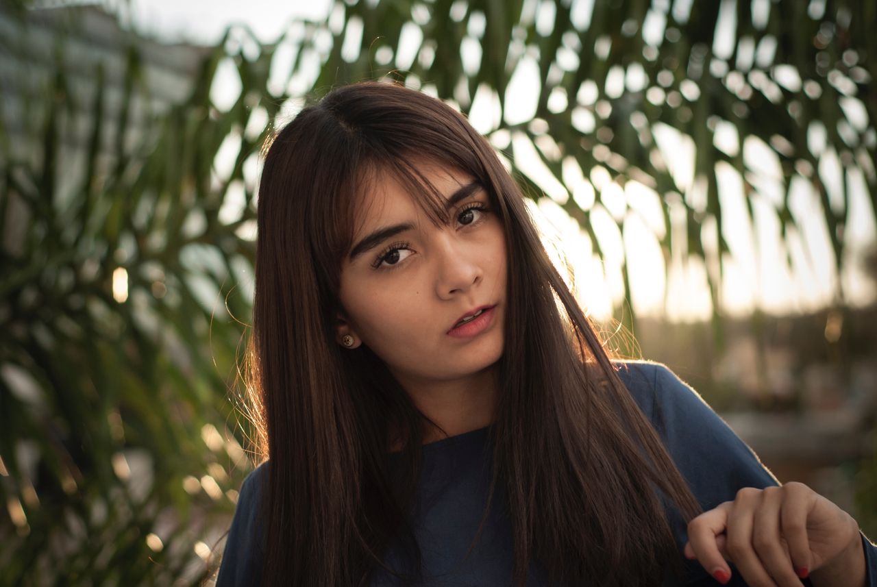 diamond studs on girl in front of tree