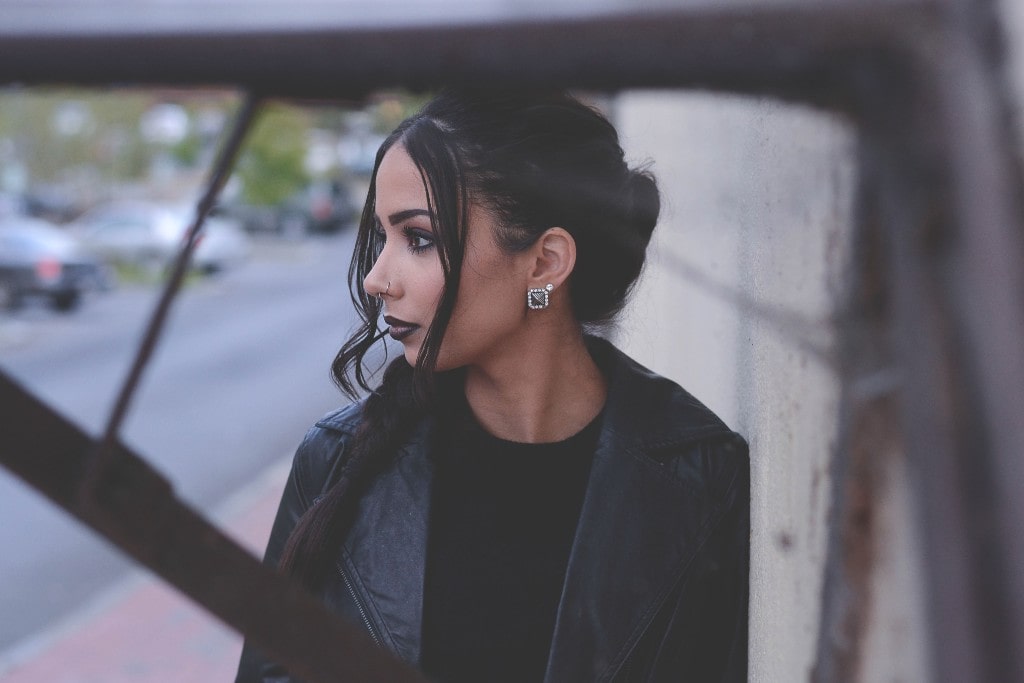 woman with two diamond stud earrings on